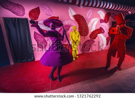Group of stylized fantasy actors in scenic make-up and bright colored background. 