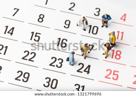 miniature people on calendar background