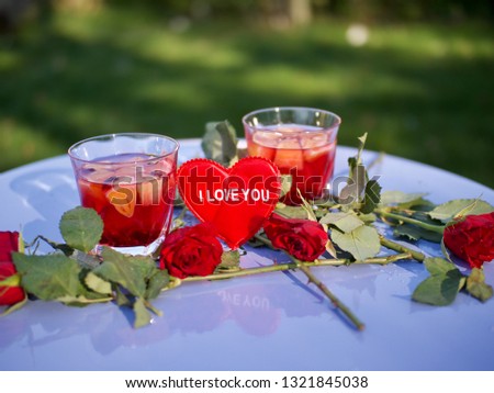 Table with dessert in glasses and roses, red heart with the inscription I love you - Image