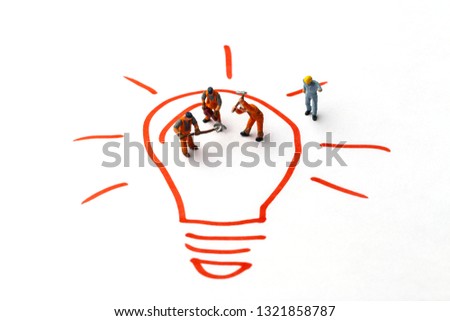 Miniature people on paper with light bulb. The concept of a collective solution to any problem. 