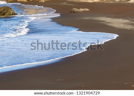 Holiday beach with brown sand in southern Spain.