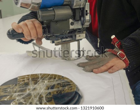                    Worker-cutting machine using machinery in a factory            
