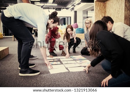 young black muslim businesswoman having meeting with her multiethnic startup business team in modern office interior,presenting new ideas on the floor