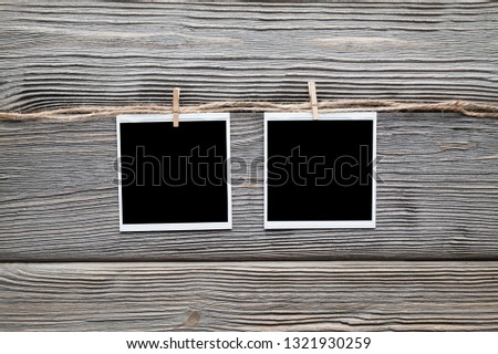 Two vintage photo frames with empty space on wooden background