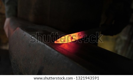 About artistic Forging of Metal. Blacksmithing. Pattern and forms for the artist blacksmith. Treatment of molten metal close-up. Handmade blacksmith