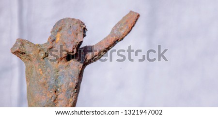 Partially destroyed ancient iron statue of the crucifixion of Jesus Christ. Faith, religion, suffering, love, God concept