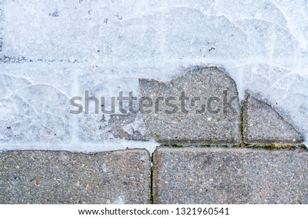 Paving slabs on walkway with ice. Studio Photo