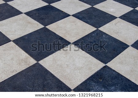 floor with chess-shaped black and white tiles