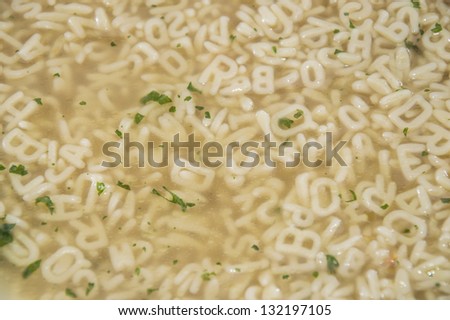 Fresh made Alphabet Soup with herbs (background picture)