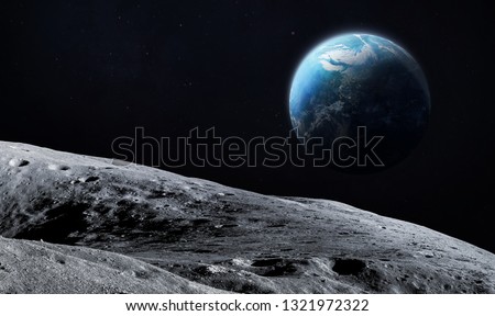 Surface of the Moon. Earth on background. Satellite of our planet. Elements of this image furnished by NASA