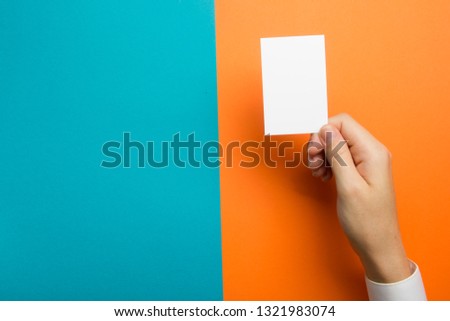 Hand holding business card blank on abstract background