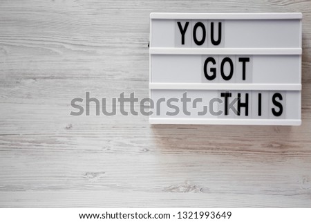 Modern board with 'You got this' words over white wooden surface. Business concept. Overhead, top view, from above. Flat lay. Copy space.