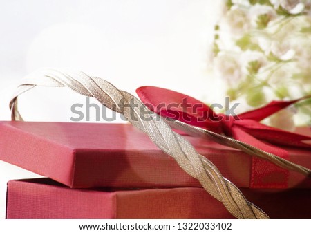 Gift box, silver necklace, flowers of graceful gypsophila (Gypsophila elegans). The concept of a gift to a woman. Selective focus, copy space.