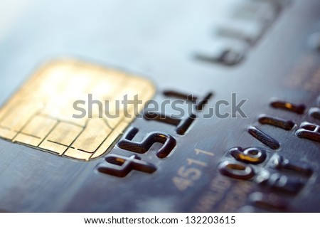 Low key macro shot with old credit card. Close up of chip for secure payment. Royalty-Free Stock Photo #132203615