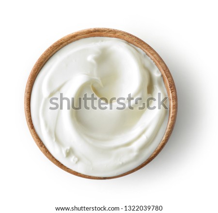 wooden bowl of sour cream or yogurt isolated on white background, top view Royalty-Free Stock Photo #1322039780