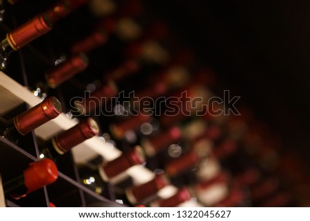 Photo of many bottles in racks.
