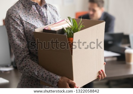 Close up view of new female employee intern holding cardboard box with belongings start finish job in company office, busnesswoman newcomer worker get hired fired on first last day at work concept Royalty-Free Stock Photo #1322058842