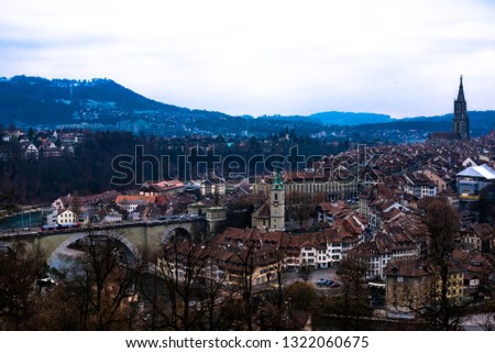Views from rosengarten of the historical Old Town of Bern city, tiled roofs, bridges over Aare river and church tower, Switzerland