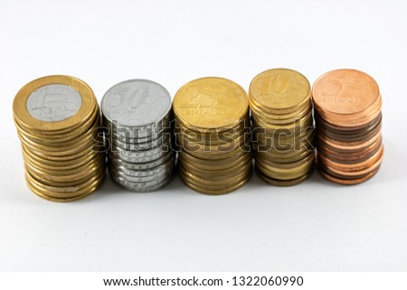 A super macro image of a pile one real, fifty, twenty five, ten and five cents isolated on a white background