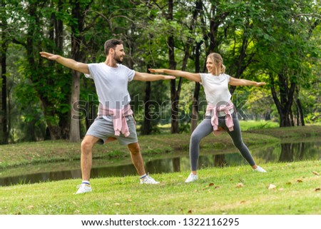 Caucasian Man and Woman exercise in public garden park in summer