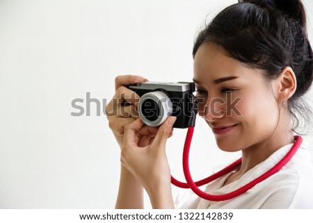 The beauty lady holding camera in hands,prepare for taking photo,with smile and happy feeling