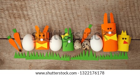 Cute creative photo with easter eggs, papaer cratf diy chiken and the Easter Bunny, holiday springtime concept, copy space.