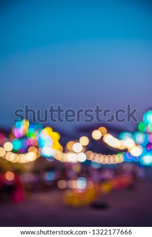 vintage tone vertical blur image of festival is celebrated at night with bokeh from the lights that are decorated throughout the event for background