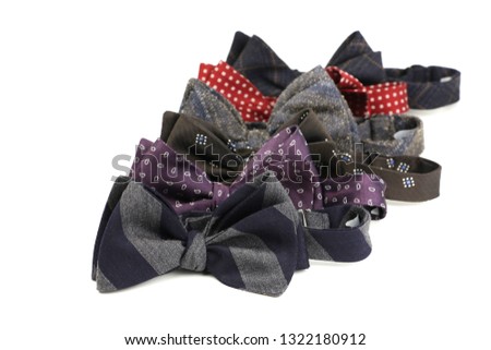 group of stylish bow ties different colors one after another on white background postcard for congratulatory texts, copy space, closeup