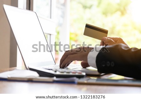 Hands holding credit card and using laptop. Online shopping. Online payment - Image