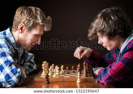 two chess players at a chess game in the evening