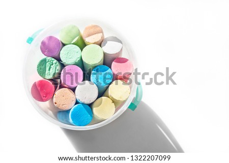 Pack of Jumbo Sidewalk Chalk, Assorted Colors in a Plastic Bucket on White Background with Shadow. Top View. Royalty-Free Stock Photo #1322207099