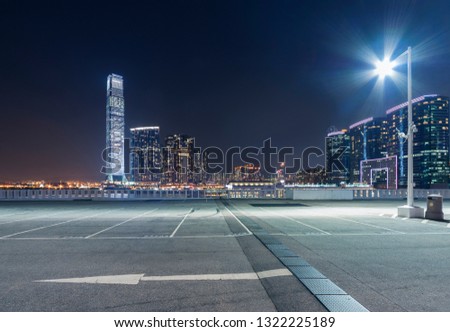 empty car park with city skyline background