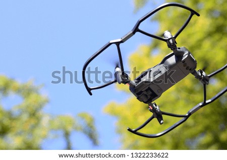 Drone with photocamera take off from land and flying for take aerial photo