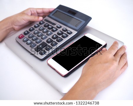 Equipment for working and accounting with a notebook computer calculator And mobile phones on white table.