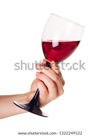 glass of red wine  in female hand on isolated white background
