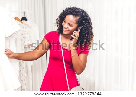 African american woman shopping and choosing clothes in a store.fashion shopping concept