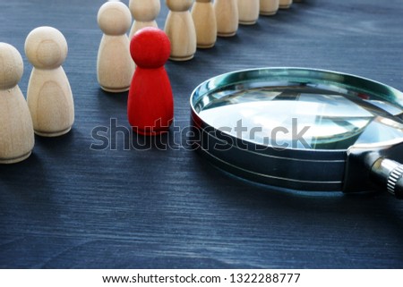 Identify concept. Recruitment and talent management. Red figurine and magnifier. Royalty-Free Stock Photo #1322288777