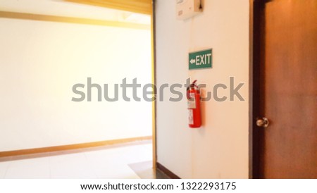 Blur image of fire exit in the building.