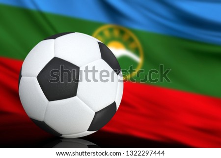 Soccer black and white ball close up, in the background a blurred flag of Karachay Cherkessia. The image takes place for your text.