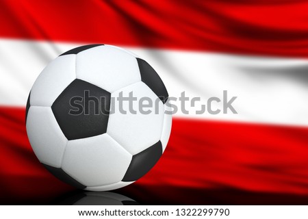 Soccer black and white ball close up, in the background a blurred flag of Austria. The image takes place for your text.