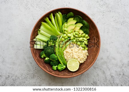 Salad bowl with quinoa and green vegetables. Green vegetables cucumber, pepper, celery, broccoli, avocado, spinach, edamame beans