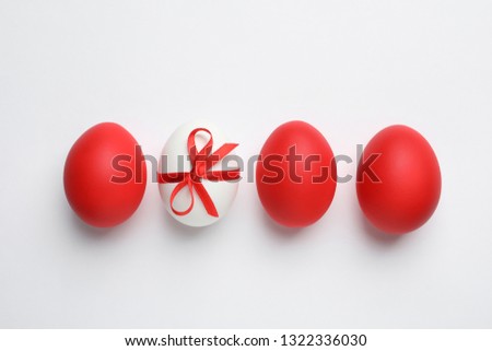 Composition of painted red Easter eggs on white background, top view