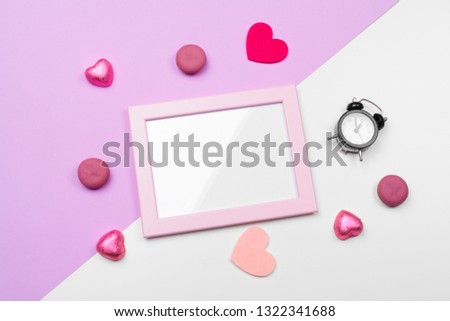 Valentines day photo frame or greeting card and handmaded hearts over table. Top view with copy space