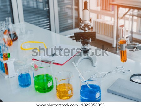 Microscopea and test tube containing chemical liquid in laboratory, lab chemical research and development,
scientific and medical concepts