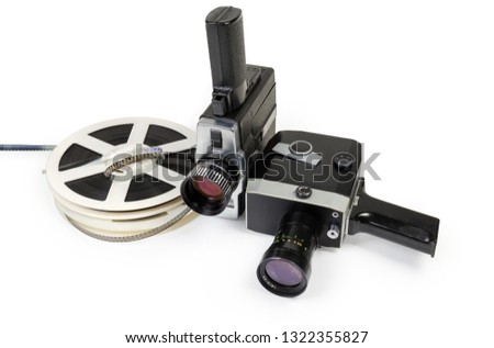 Two different vintage amateur film movie cameras and reels of color motion picture films Super 8mm format close-up on a white background 
