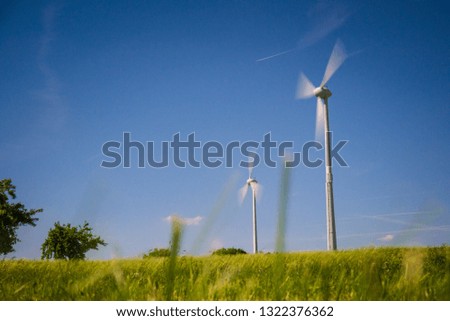 Wind generators turbines at sunset. Renewable energy concept.