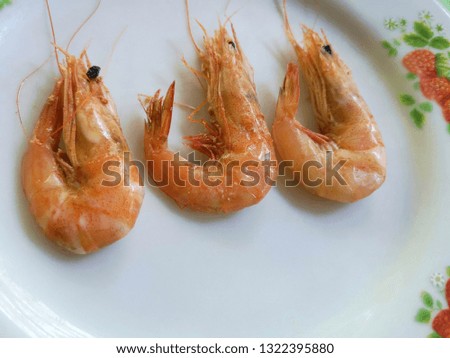 Shrimps on white dish.