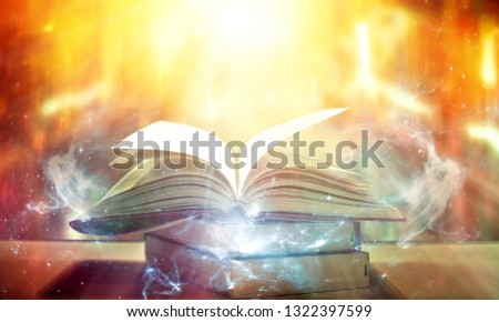 Abstract gold magic book on wooden background