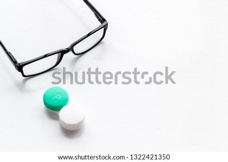 Eye problems. Glasses with transparent lenses and contact lenses on white background space for text