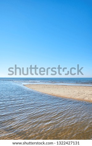 View of a beach with shallow water.